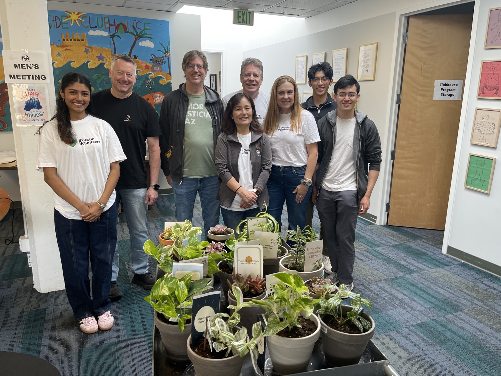 JCP volunteers and Westside Clubhouse members gathered behind the plants they created